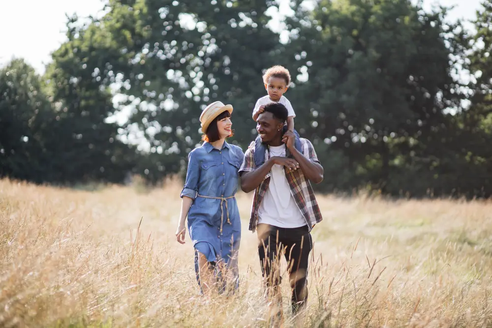 Family walking through a sunny field in San Jacinto County, Texas